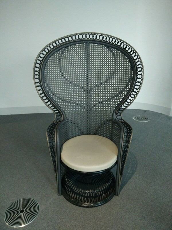 A unique high-backed wicker chair