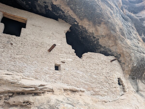 Stone ruins built into a cliff cave