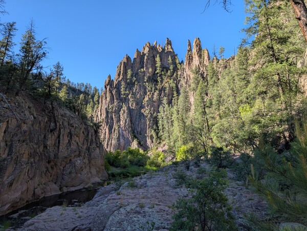 Huge rock spires look over a bend in the river