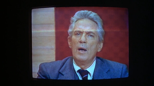 Howard Beale delivering the nightly news on television