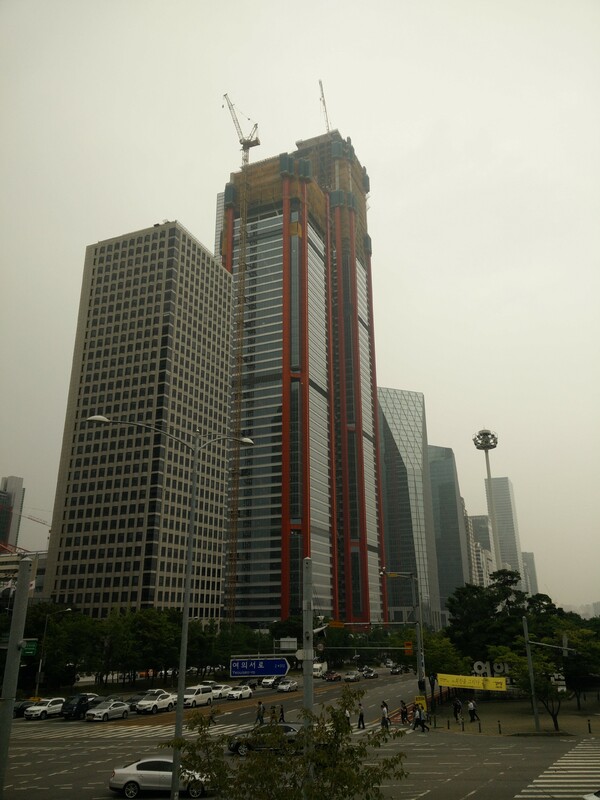 A skyscraper under construction on the banks of the Han river