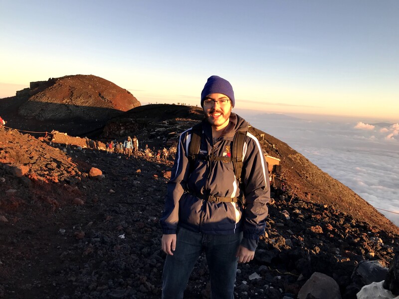 A photo of Joseph Petitti at the summit of Mount Fuji